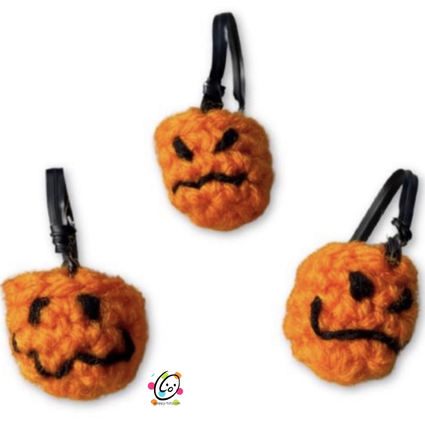 Tiny crocheted pumpkin baskets with black faces and handles by Snappy Tots